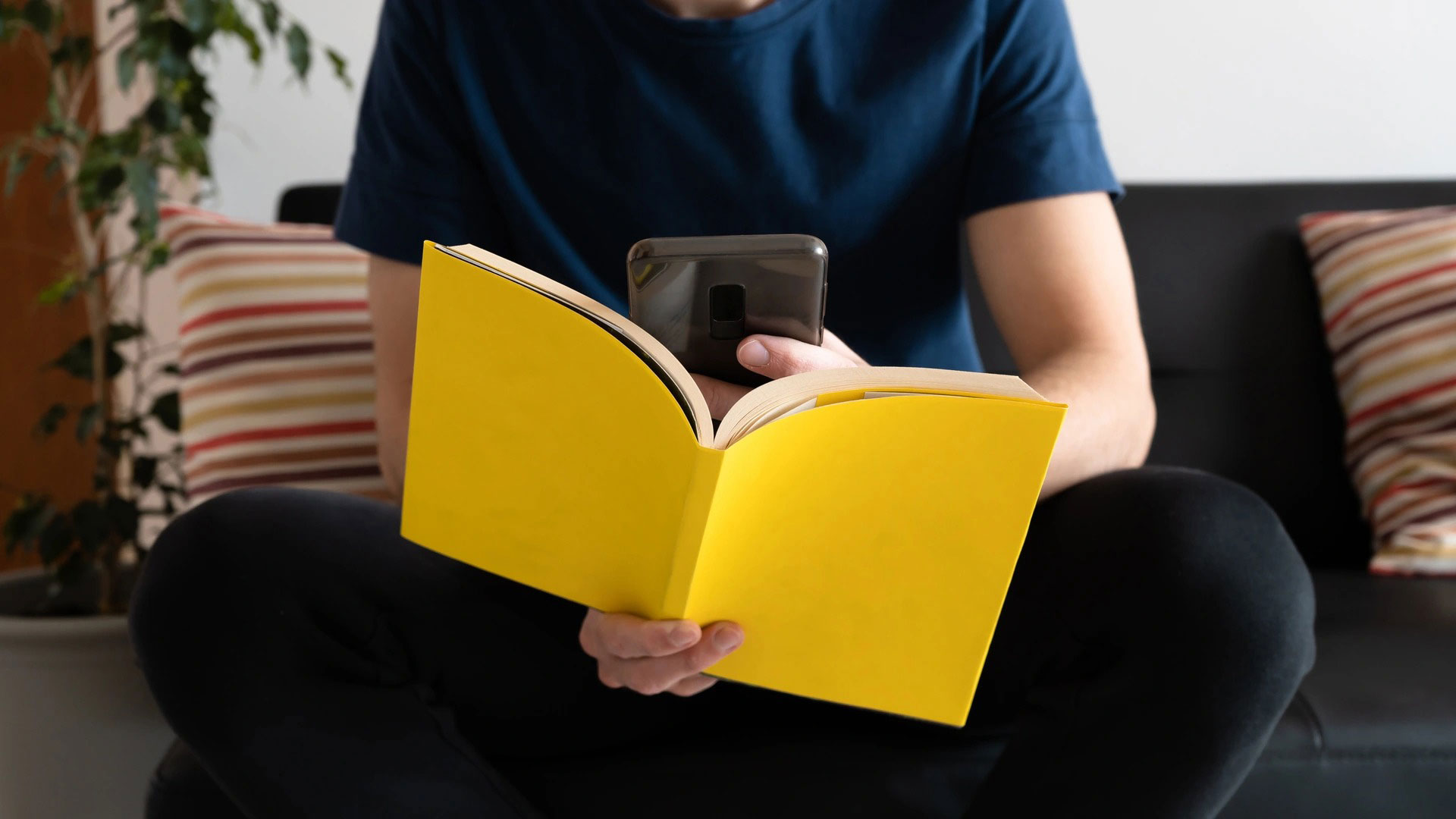 Book and phone as focal point for man reading
