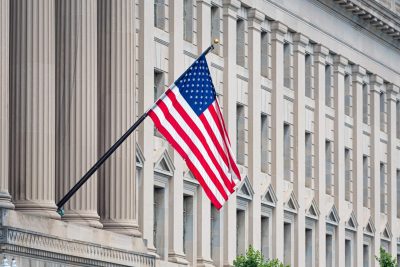 united-states-flag-flying-over-building-in-urban-a-2026-03-24-04-15-36-utc